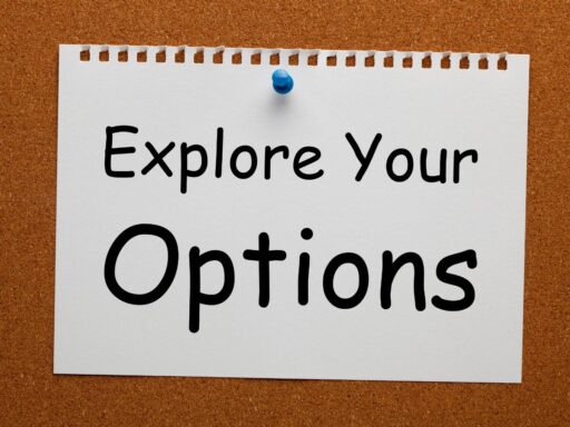 Cork board with note saying "Explore Your Options" pinned with blue thumbtack