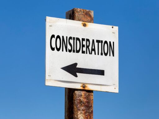 White directional sign with "CONSIDERATION" text against blue sky background.