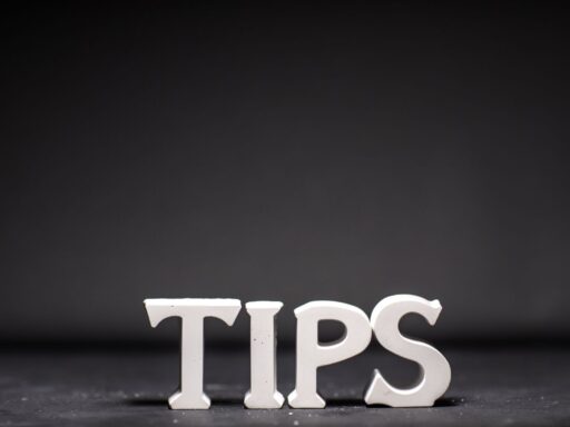 White "TIPS" text against dark background - minimalist typography design.