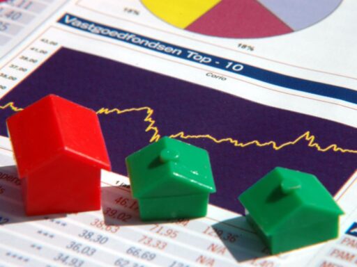 Monopoly-style houses on financial chart showing market trends and data