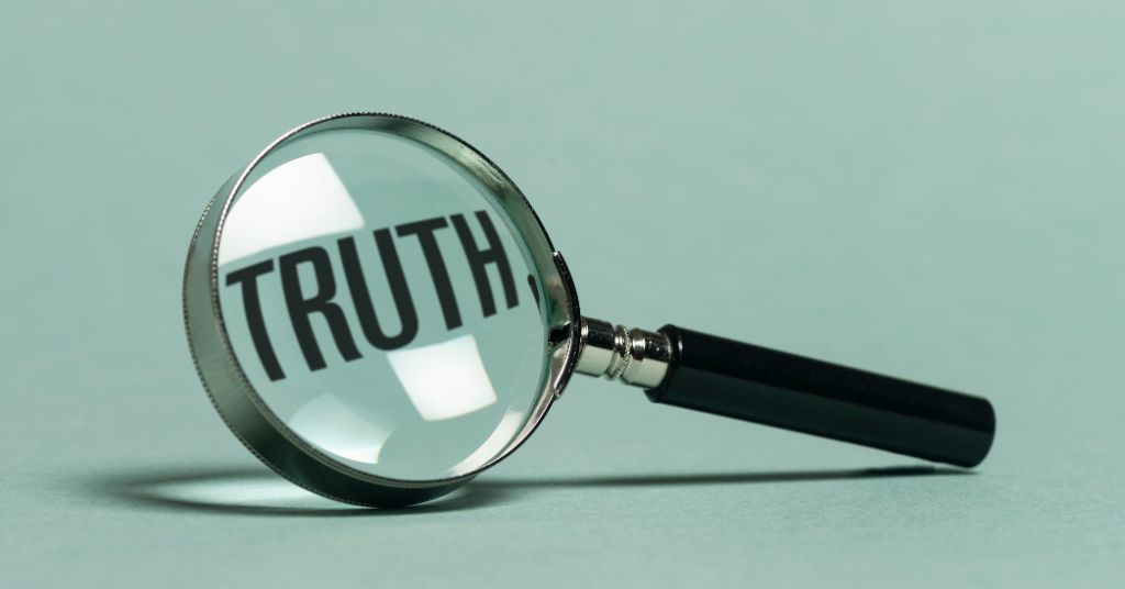 A magnifying glass showing the word "TRUTH" against a mint green background.